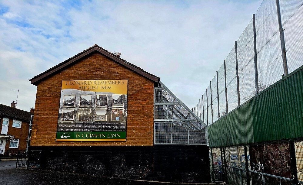 Clonard Remembers August 1969 mural beside the Peace Wall in West Belfast — a community memorial to the riots that sparked the Troubles